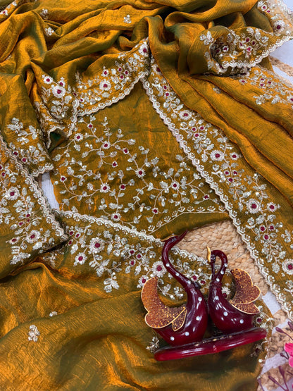 An antique gold Fandy silk saree showcasing fine hand embroidery in gold and red threadwork. The scalloped border and rich fabric texture highlight timeless craftsmanship and traditional beauty.