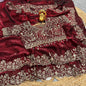 A bridal maroon soft space silk saree decorated with ornate golden floral embroidery and detailed border work. The designer blouse with intricate thread and sequin embroidery completes this luxurious wedding-ready ensemble.