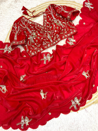 A bridal red space silk saree beautifully handcrafted with intricate bird embroidery and sequin embellishments. The matching blouse enhances its royal appeal, making it perfect for weddings and celebrations.