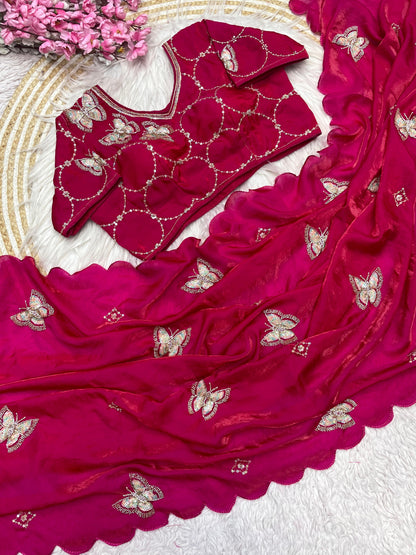 A bright Rani-colored space silk saree featuring heavy golden and silver butterfly embroidery. The saree is paired with a matching embroidered blouse, exuding a regal and luxurious bridal charm.