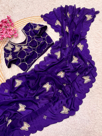 A deep purple space silk saree decorated with zari and sequin butterfly embroidery. The stitched blouse matches perfectly with circular embroidered motifs, offering a regal and luxurious vibe ideal for weddings and parties.