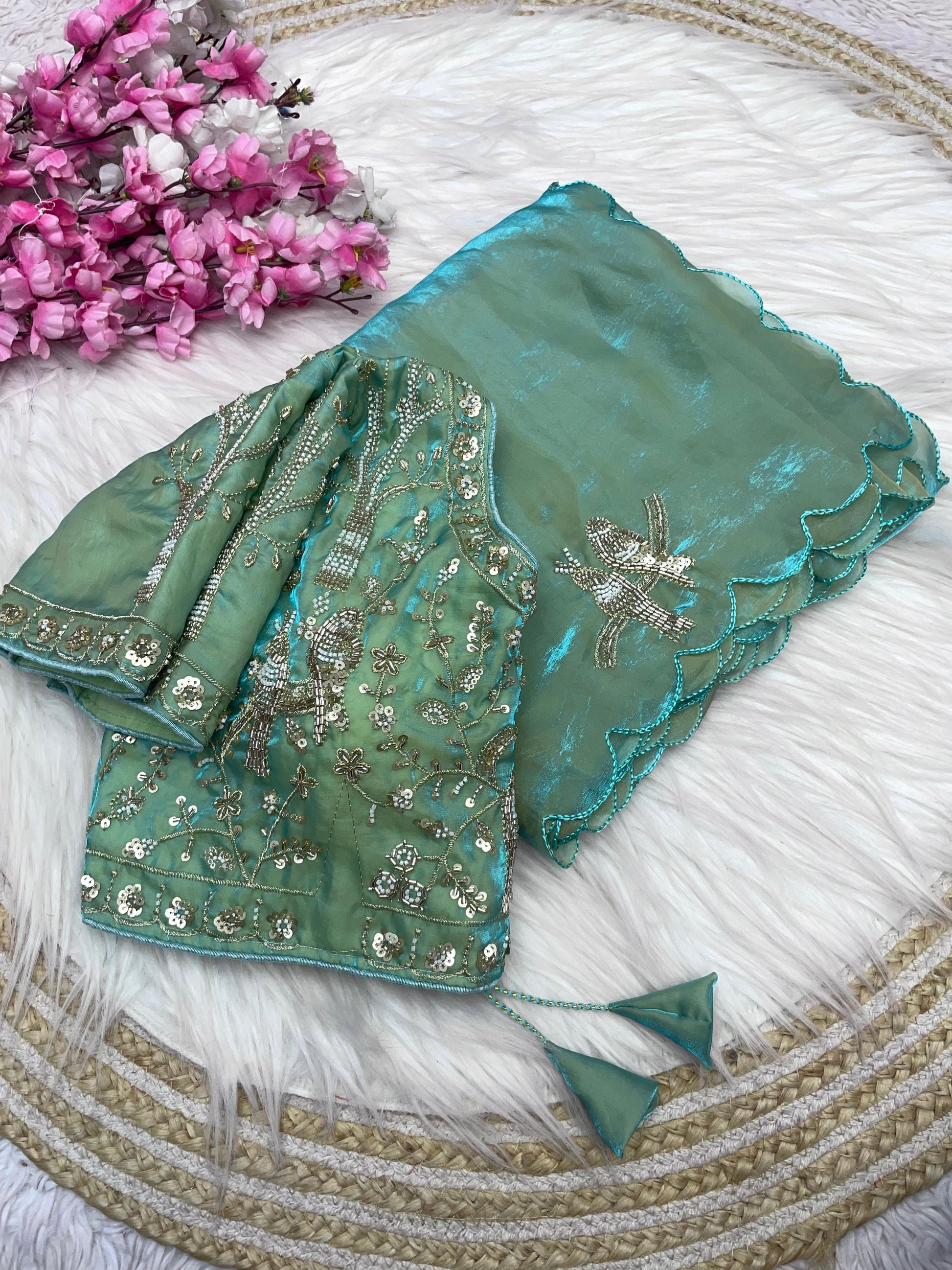 A designer pista space silk saree featuring elegant golden and silver bird embroidery along the fabric and borders. The matching stitched blouse showcases rich embroidery, making it perfect for weddings and celebrations.