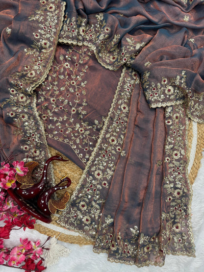 A dusty lavender Fandy silk saree adorned with heavy golden zari embroidery and fine sequin detailing. The matching blouse piece enhances its luxurious appeal, making it perfect for weddings and grand festive occasions.