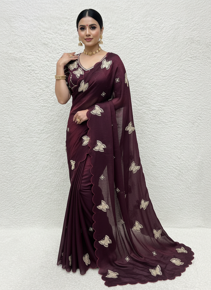 A rich maroon space silk saree featuring intricate butterfly embroidery and scalloped borders. The saree is paired with a matching stitched blouse adorned with circular sequin patterns and butterfly motifs, creating a perfect festive and elegant look.