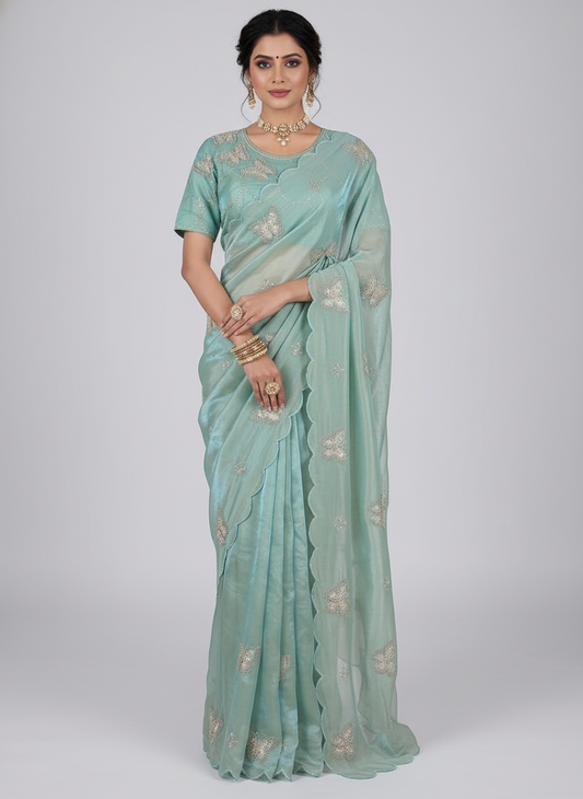 A beautiful pista green space silk saree featuring delicate butterfly embroidery and scalloped edges. The saree is paired with a matching stitched blouse adorned with sequin and thread embroidery, creating a soft, refreshing, and elegant look.