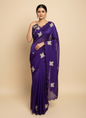 A luxurious purple space silk saree adorned with golden butterfly embroidery and scalloped edges. The saree is paired with a matching stitched blouse featuring circular sequin patterns and butterfly designs, perfect for festive and party occasions.