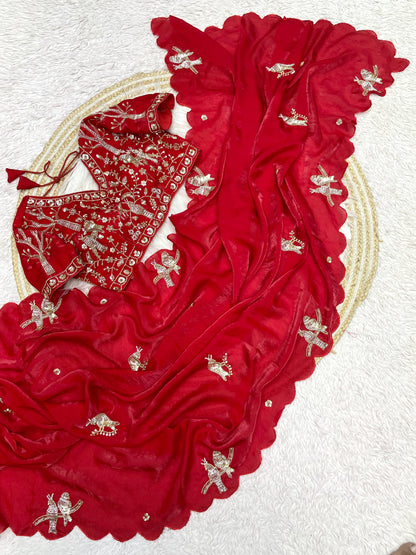 A scarlet red space silk saree detailed with silver bird motifs and scalloped borders. The outfit includes a coordinating embroidered blouse, creating a festive, elegant, and glamorous ethnic look.