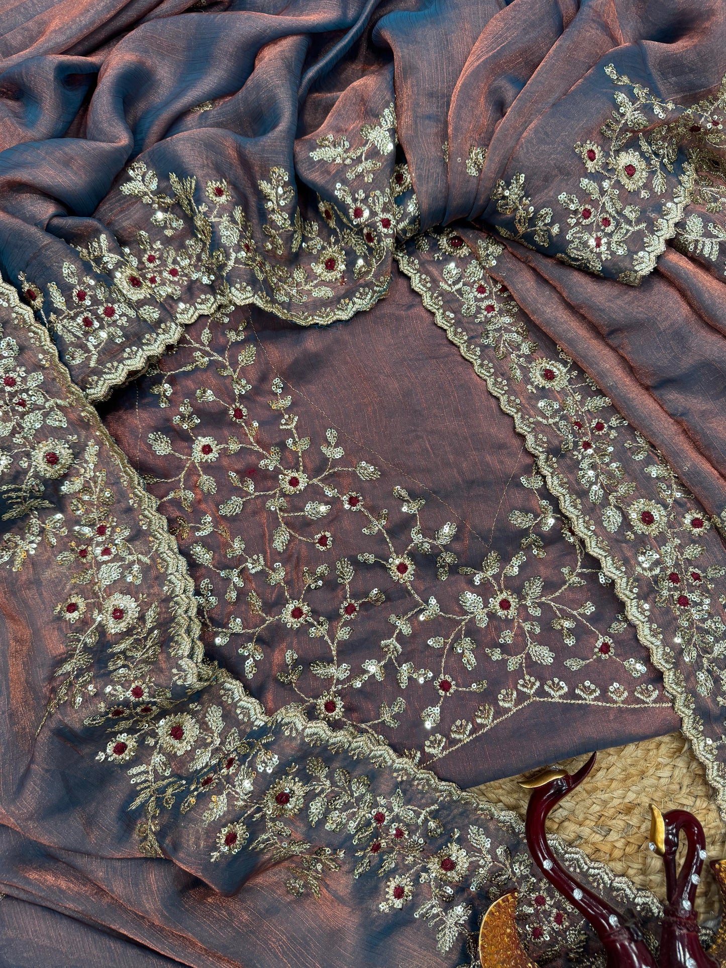 A soft lavender Fandy silk saree embellished with sequin floral embroidery and a delicately designed border. The matching embroidered blouse adds an elegant finish, ideal for both traditional and contemporary celebrations.