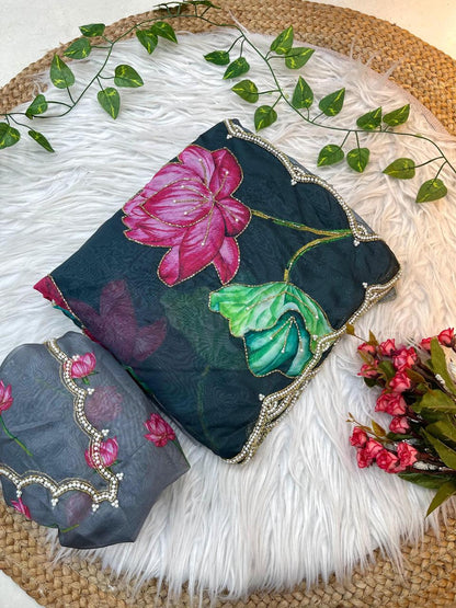 A feminine soft organza saree decorated with multicolor lotus motifs and bordered with pearl scalloped lace. Paired with a matching blouse, this saree is perfect for festive celebrations and elegant gatherings.