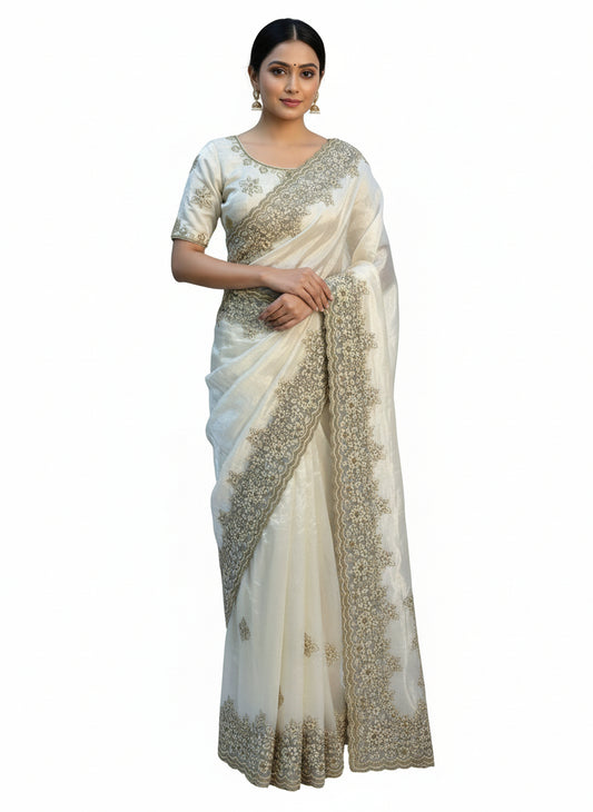 A beautiful white Fandy silk saree featuring intricate golden floral embroidery along the border. The saree includes a matching blouse embellished with coordinated golden motifs, creating an elegant and festive ethnic ensemble.